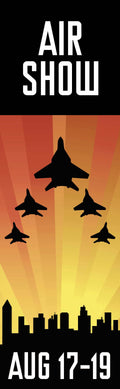 A group of fighter jets flying in formation over a city skyline at sunset. The text