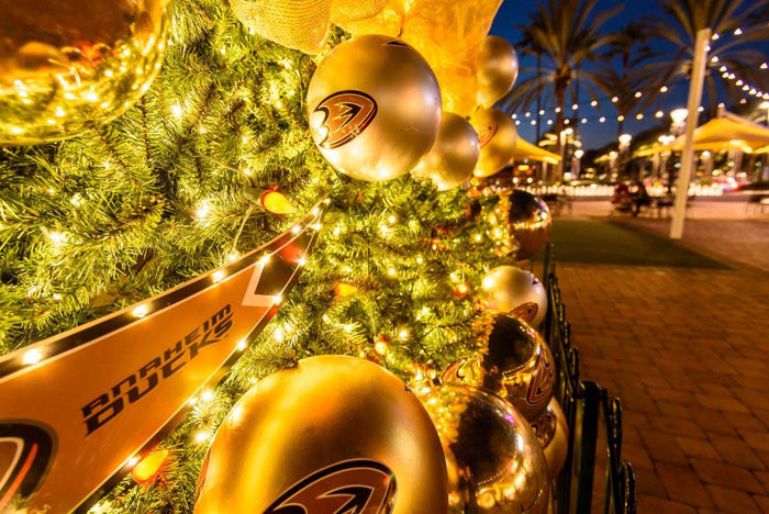 Close-up shot of a Christmas tree decorated with custom branded ornaments