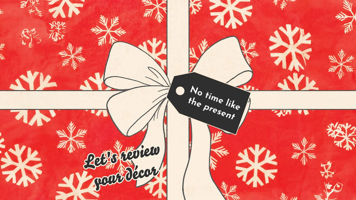 Graphic design of the top of a gift box with red wrapping paper covered in off-white snowflakes with an off-white bow. The gift tag says 