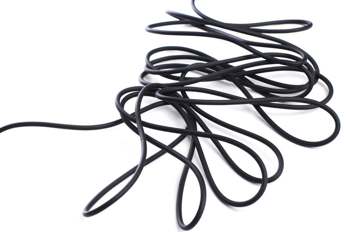 Black extension cord on the ground.