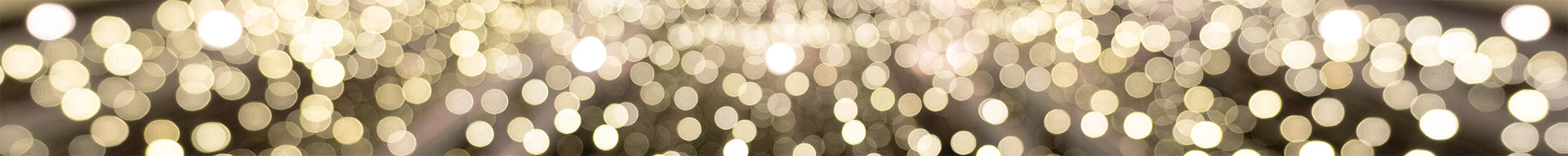 A vibrant cluster of Christmas lights, casting a warm glow on the surrounding darkness.