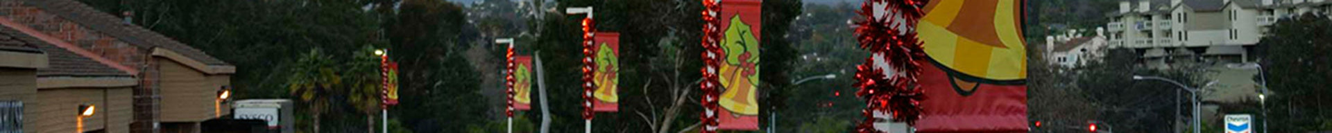 Holiday banners accented with shiny red vinyl garland.