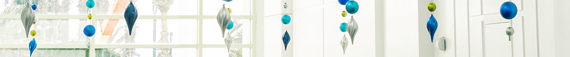 Cross section of blue and silver finial ornaments hanging from the ceiling.