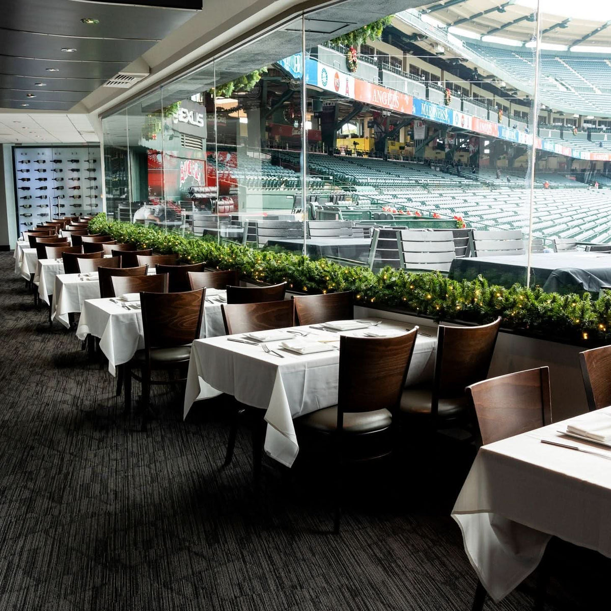 Dekra-Lite Mountain Pine Garland displayed on a ledge inside a VIP lounge