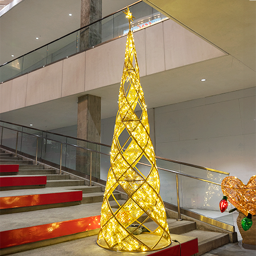 This Shinto Tree decoration, on top of stairs in a mall, is featuring a clear silicone netting that cascades over the tree in a voluminous way. Warm white mini lights are woven throughout the netting, creating a sparkling and diffused light effect. This clean and modern design gives the tree a soft, ethereal glow.