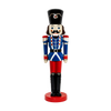 Classic nutcracker decoration featuring a blue military-style jacket, red pants, black boots, and a tall black hat on a red circular base.