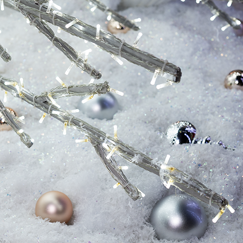 A close up shot of the decorative crystal branch tree, formed entirely from a network of cool white lights on a sturdy metal frame. This versatile piece offers a shimmering wintery effect.