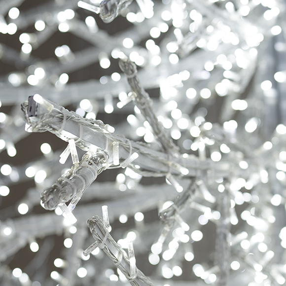 A close up shot of the decorative crystal branch tree, formed entirely from a network of cool white lights on a sturdy metal frame. This versatile piece offers a shimmering wintery effect.