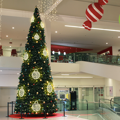 Dekra-Lite Illuminated Tolga Ornament on a Christmas tree inside a mall.