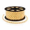 Warm White LED rope light wrapped on a black 150-foot spool, with bright green bulbs and a loose strand displayed on a white studio background.