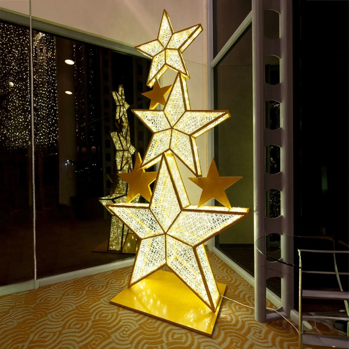 Dekra-Lites Lapua Star Stack, inside a building & illuminated at night.