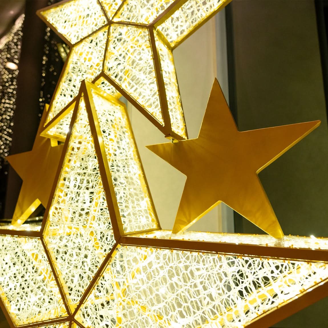 Dekra-Lites Lapua Star Stack, inside a building & illuminated at night.